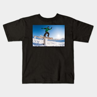 Snowboarder sliding on a rail Kids T-Shirt